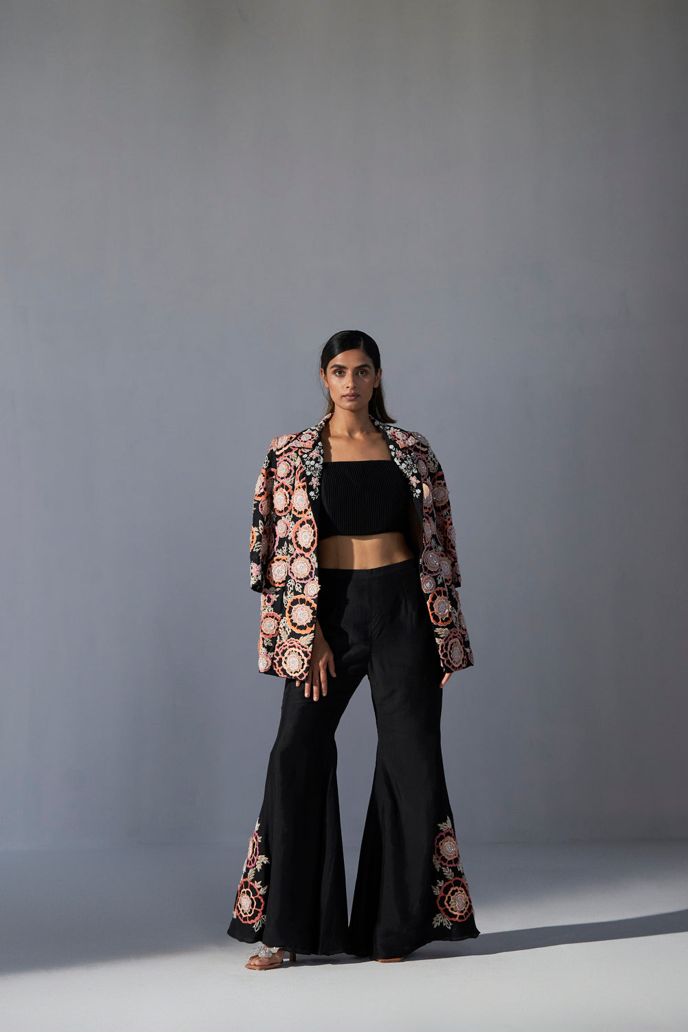 Black floral embroidered jacket with bustier and bell bottom pants