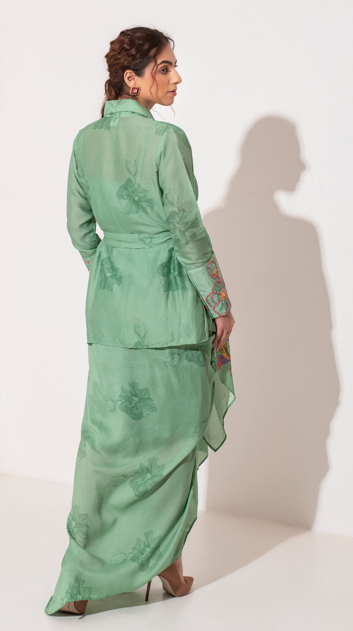 Pista green placement printed asymmetric jacket bustier and draped skirt.