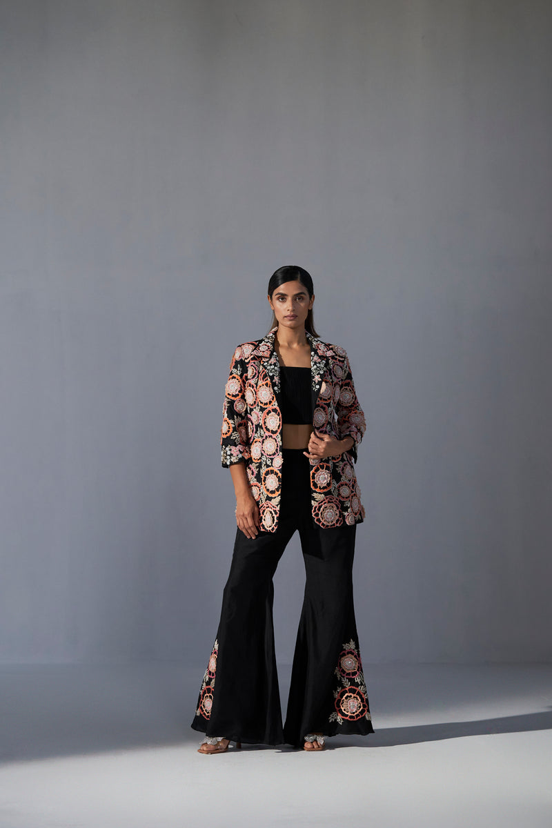 Black floral embroidered jacket with bustier and bell bottom pants