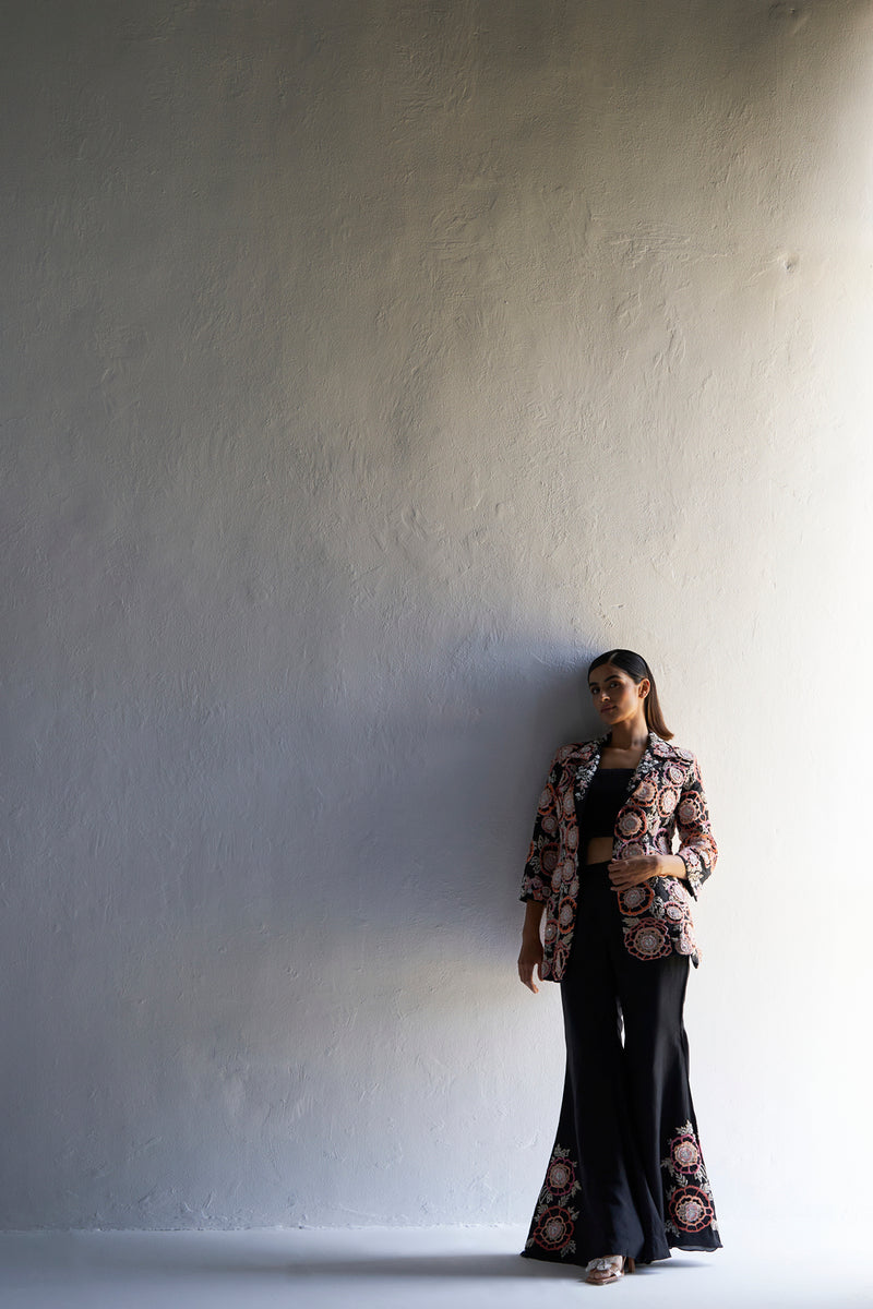 Black floral embroidered jacket with bustier and bell bottom pants