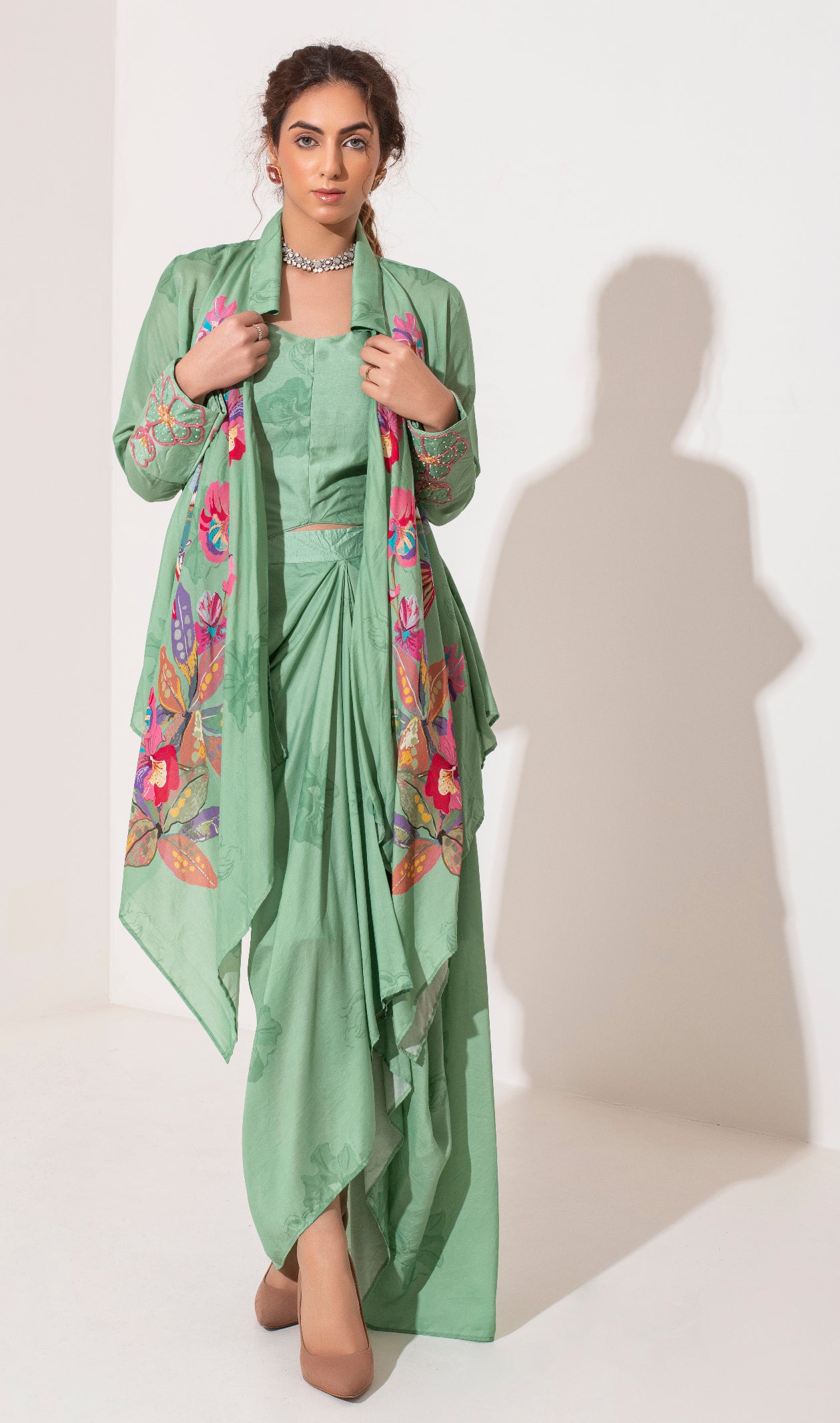 Pista green placement printed asymmetric jacket bustier and draped skirt.